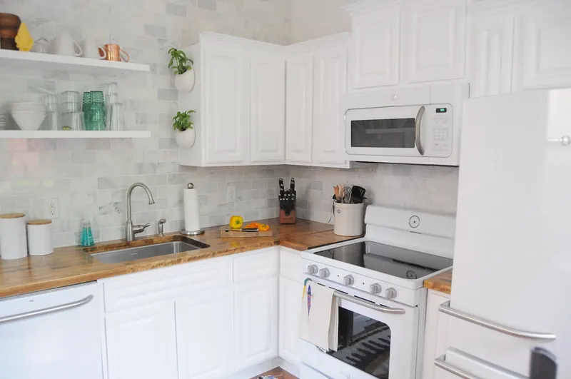 Stove, microwave, and refrigerator in a family kitchen